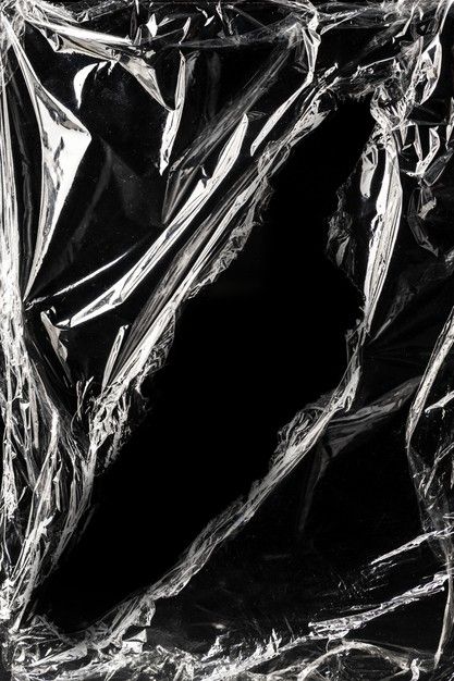 Wrinkled plastic wrap texture on a black background | Free Photo